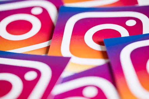 A scattered pile of printed cards, each showing the Instagram logo