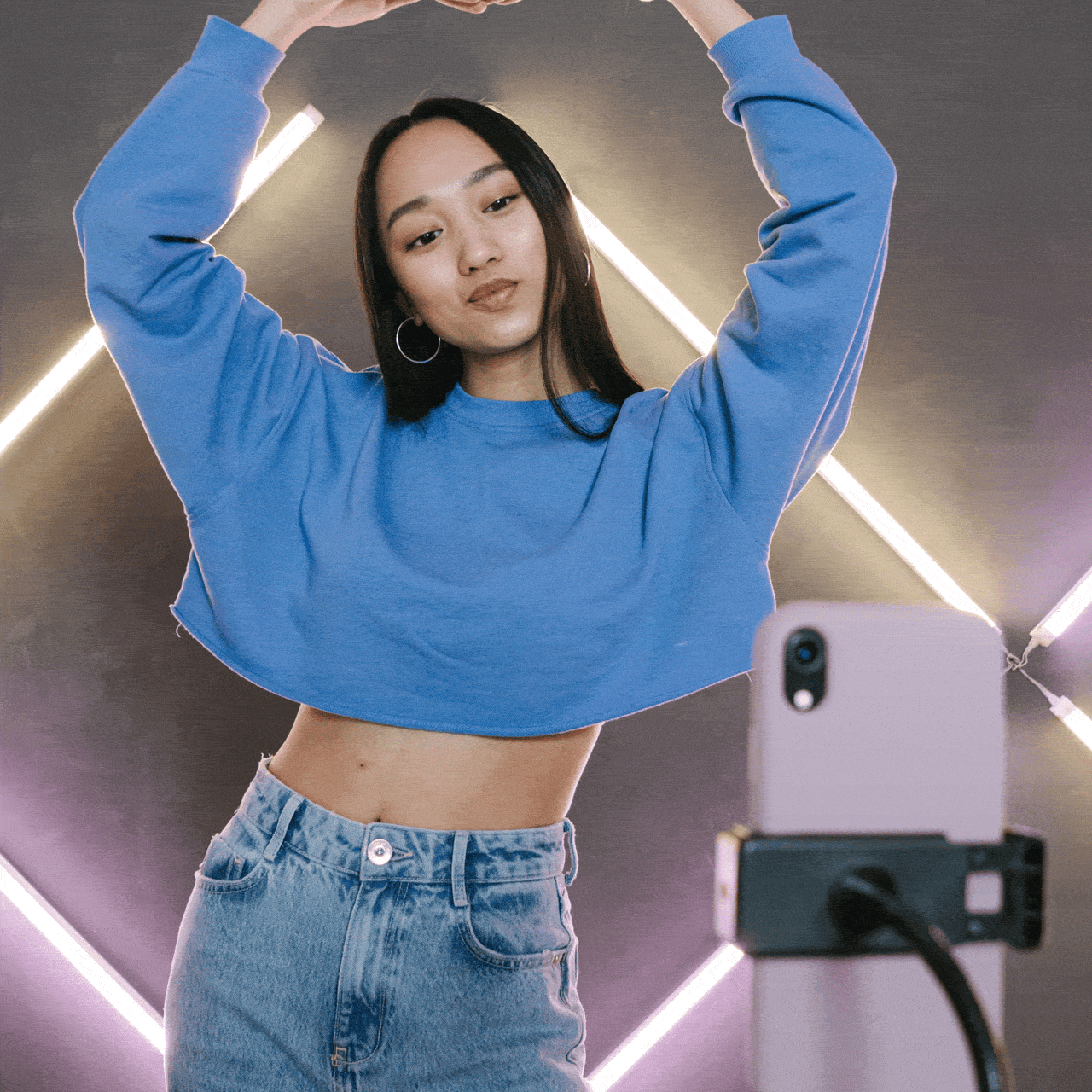 Creator filming content on a phone with ring light setup